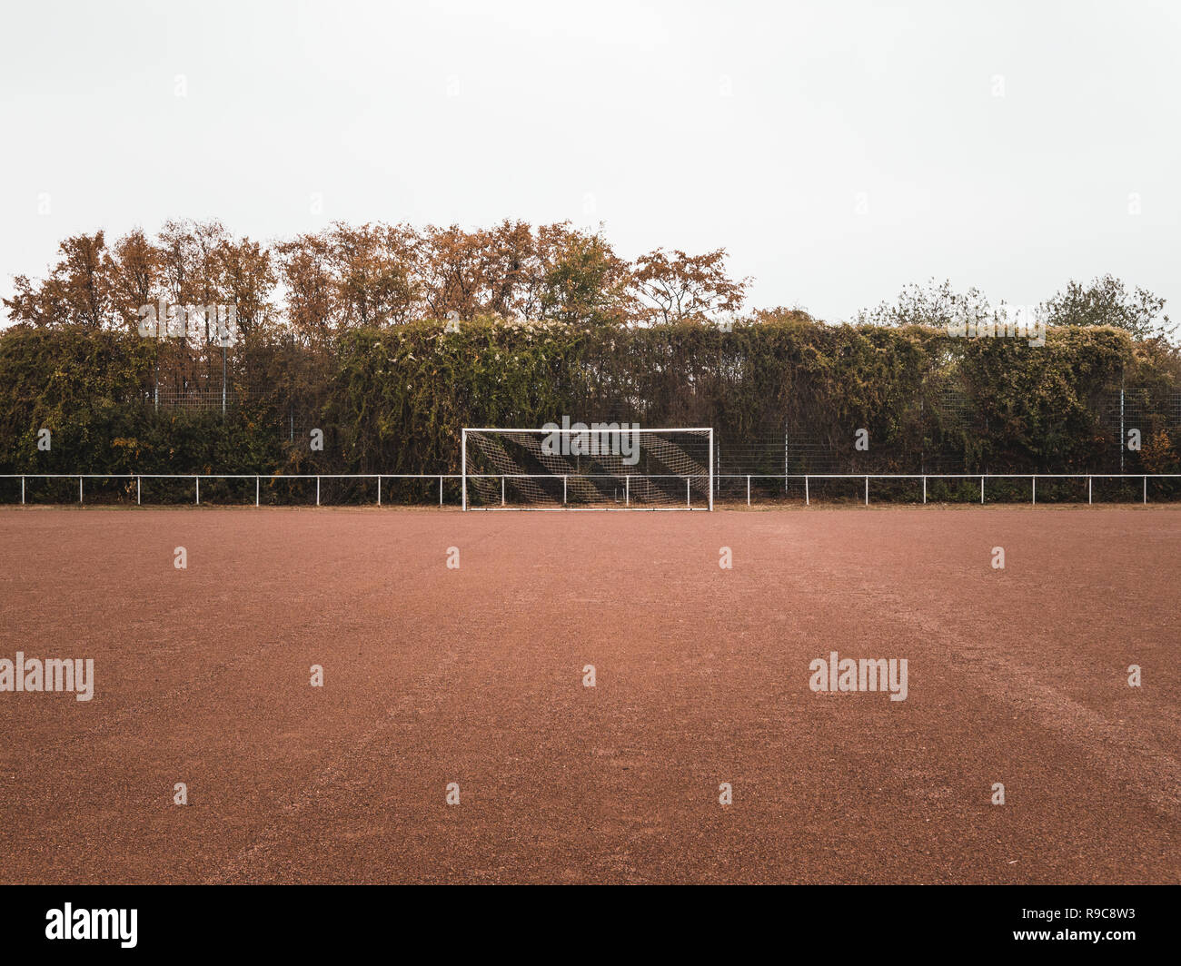 Symmetrical shot of a Rural Cinder soccer pitch in Germany Stock Photo