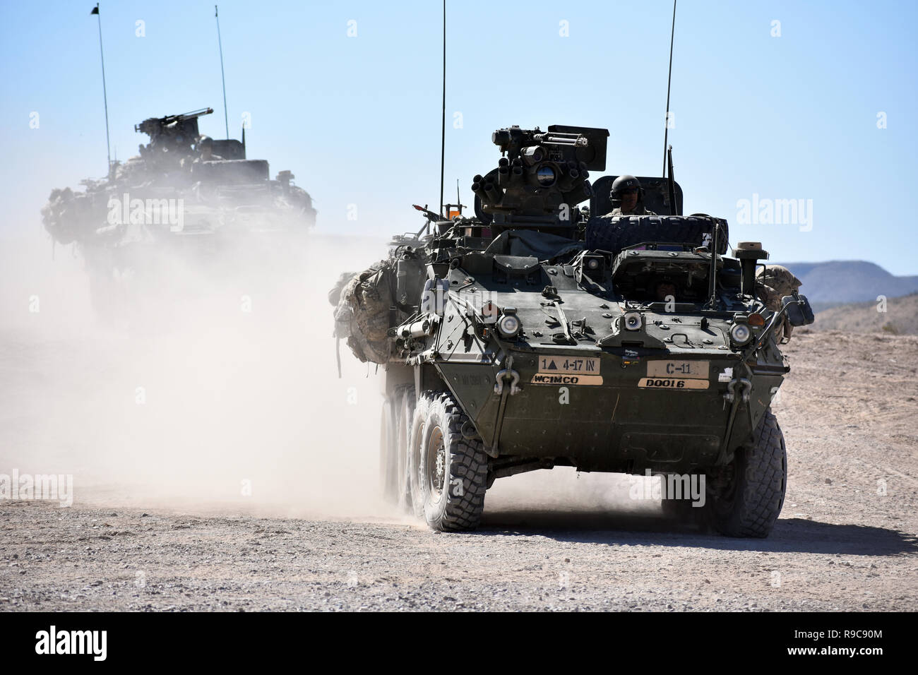 Stryker combat vehicles assigned to Company C, 4th Battalion, 17th Infantry Regiment, 1st Stryker Brigade Combat Team, 1st Armored Division, enter the Malakhand Training Village, Orogrande Range Complex, N.M., June 24, 2018. Stock Photo