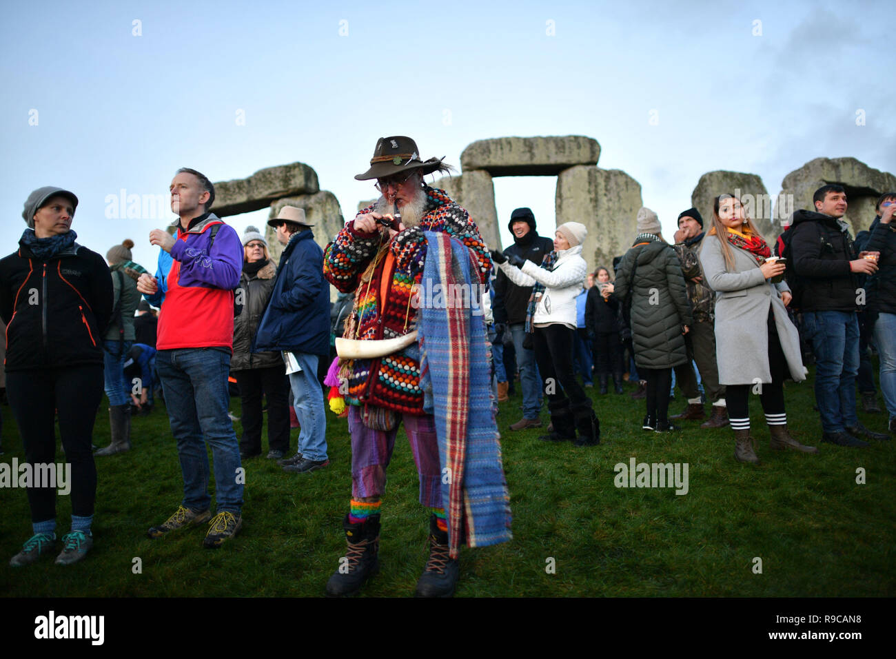 A man lights a pipe at Stonehenge in Wiltshire as people gather to mark ...