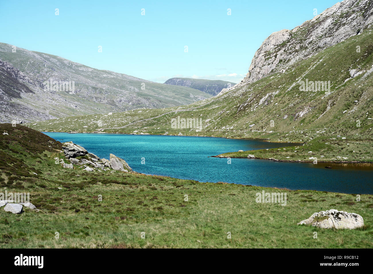 Cwm Idwal is a cirque (or corrie) in the Glyderau Range of the Snowdonia National Park. Here the green water of lake (Llyn Idwal) has been enhanced. Stock Photo