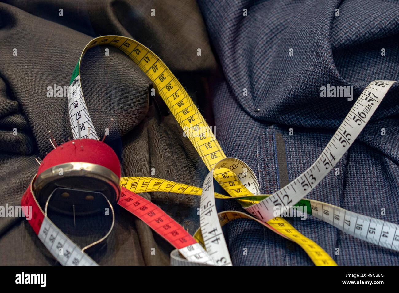 tailor instruments stuff on clothes fabric suits background Stock Photo ...