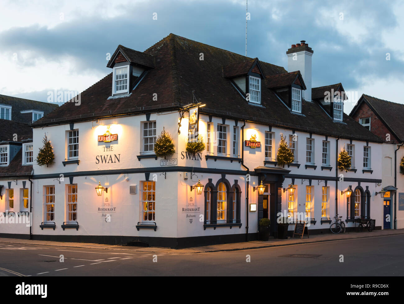 The Swan Hotel - A Fuller's pub and restaurant with bedrooms - Lit up late afternoon in Winter in Arundel, West Sussex, England, UK. Stock Photo