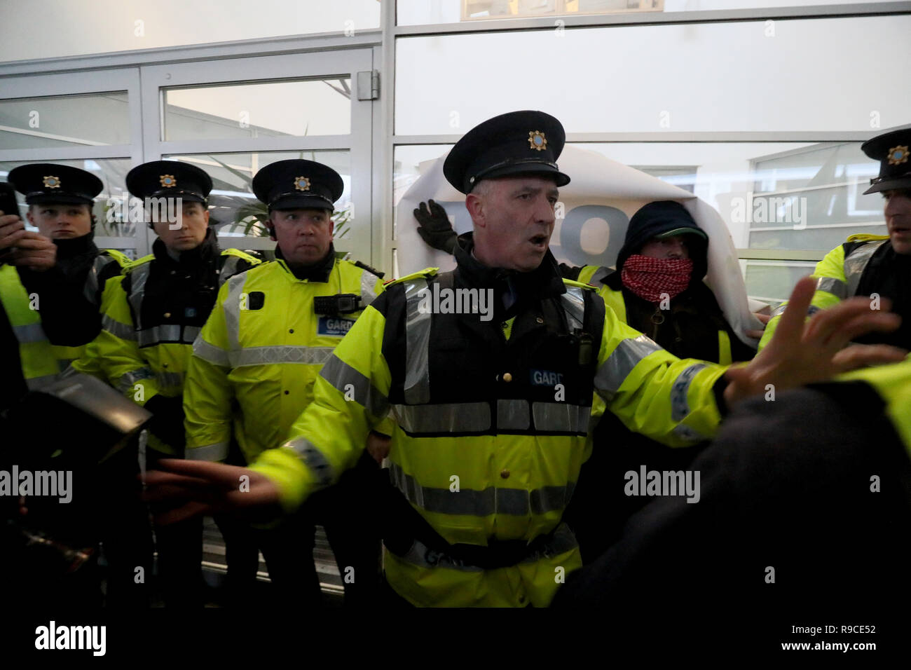 Members of the Garda protect the entrance to the KBC Bank on Sandwith Street in Dublin as Yellow Vest Ireland protestors approach during a demonstration against the Irish government's record on a range of social issues, including the housing crisis and recent evictions. Stock Photo