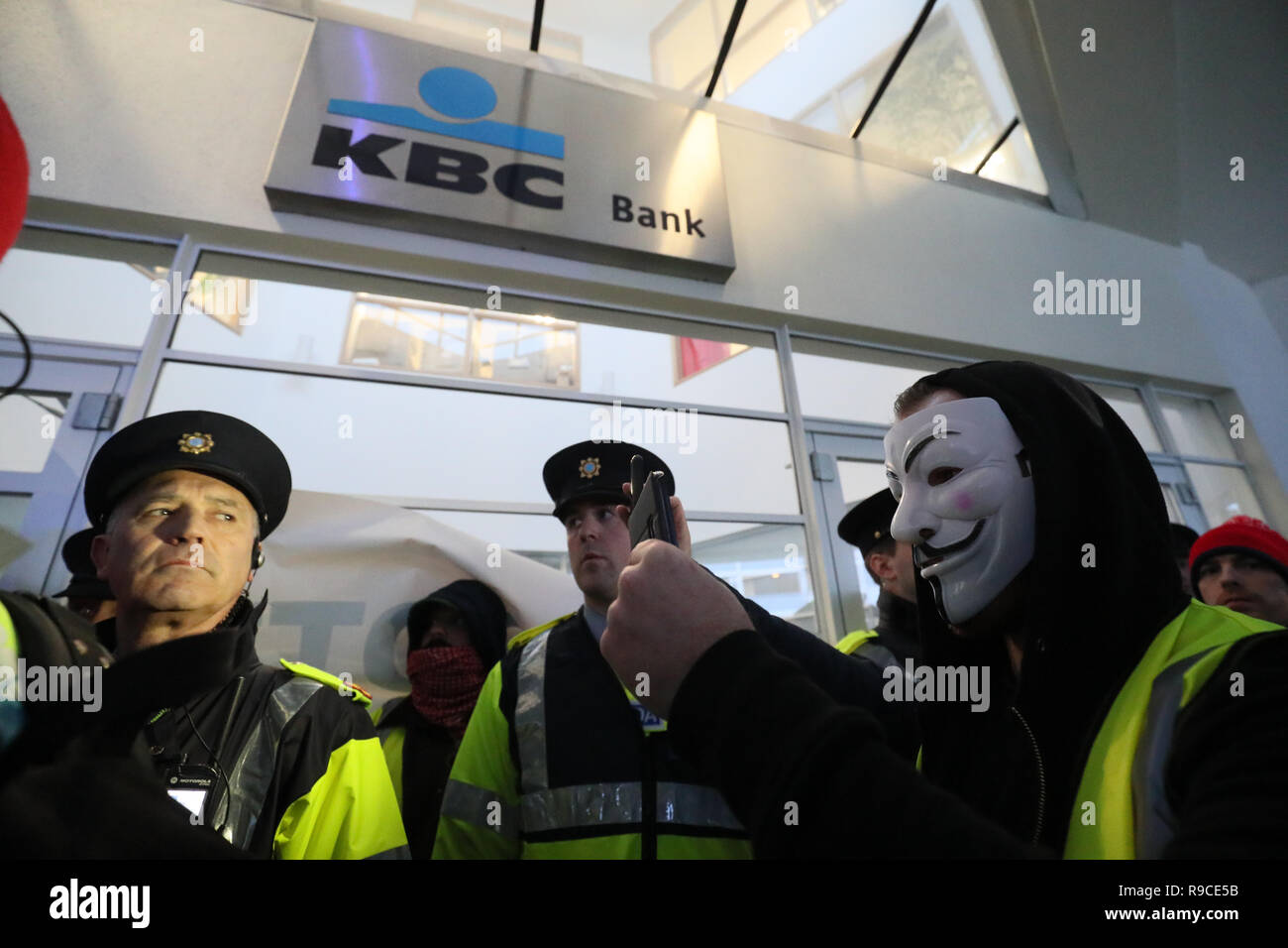 Campaigners from Yellow Vest Ireland outside KBC Bank on Sandwith Street in Dublin as Garda protect the entrance, during a demonstration against the Irish government's record on a range of social issues, including the housing crisis and recent evictions. Stock Photo