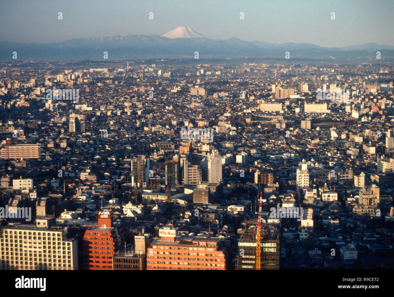 Mount Fuji is scene in the distance over a city neighborhood in Tokyo, Japan Stock Photo