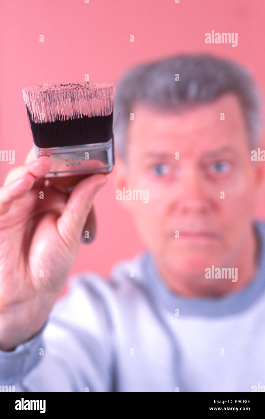 Mature man paints the interior of his home, USA Stock Photo Alamy