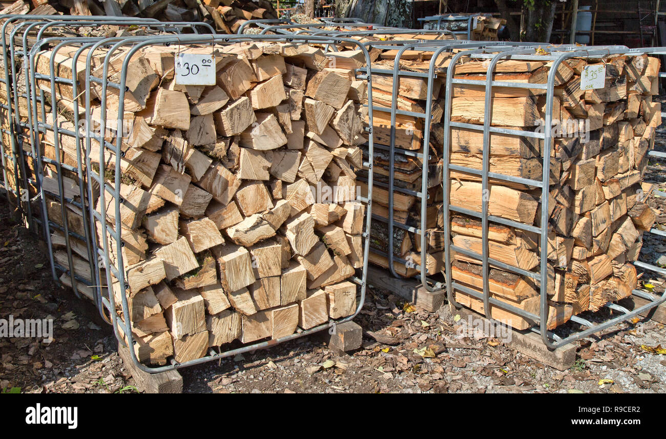 Split firewood, open-end bins with pricetags, firewood opertion & sales yard. Stock Photo