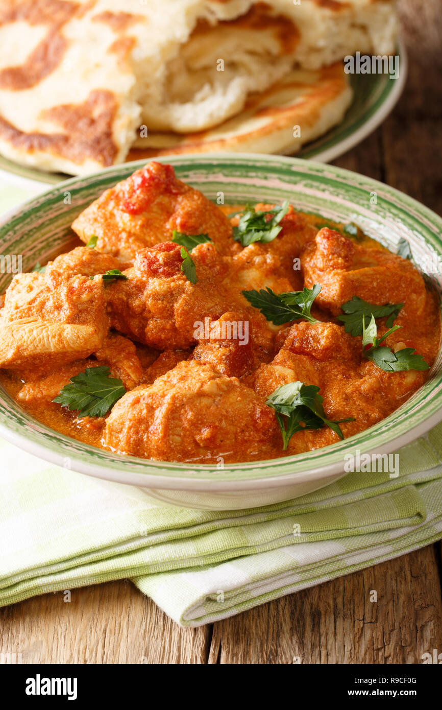 Indian Karhai Chicken In A Spicy Sauce Close Up Served With Naan Bread On The Table Vertical Stock Photo Alamy