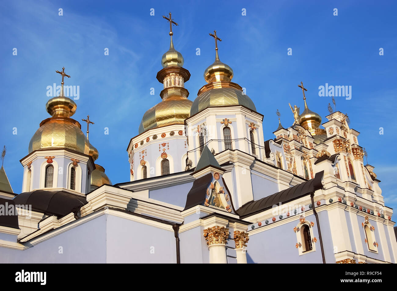 View of the shining domes of the St. Michael the Golden-Domed Cathedral in Kiev in the rays of the setting sun, the Cathedral of the Orthodox Church o Stock Photo