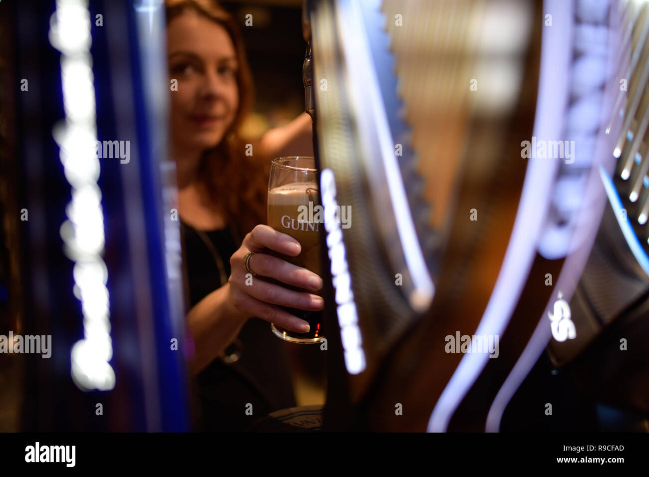 woman serving drinks in a bar Stock Photo