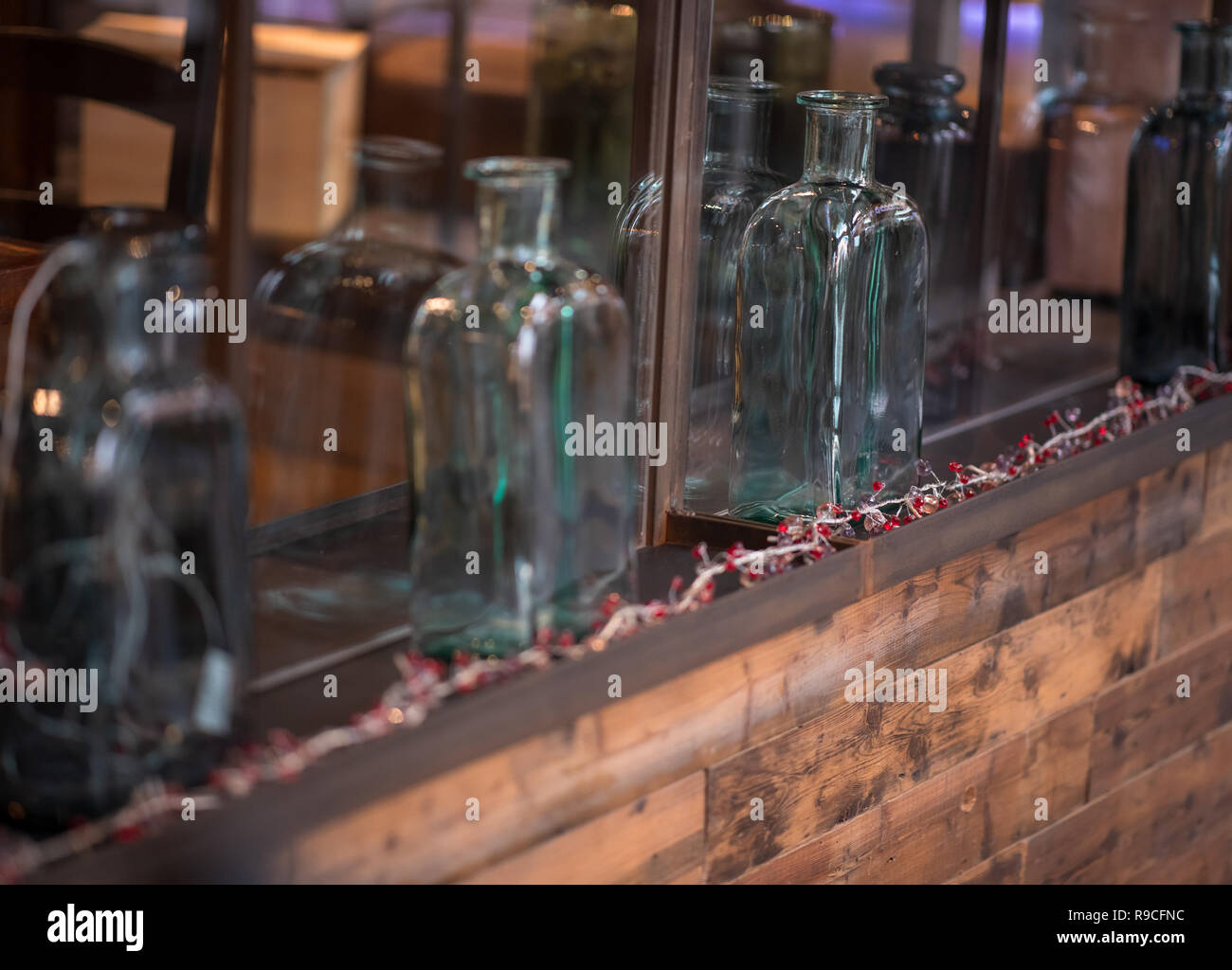 Antique Glass bottles on shelf as ornaments Stock Photo