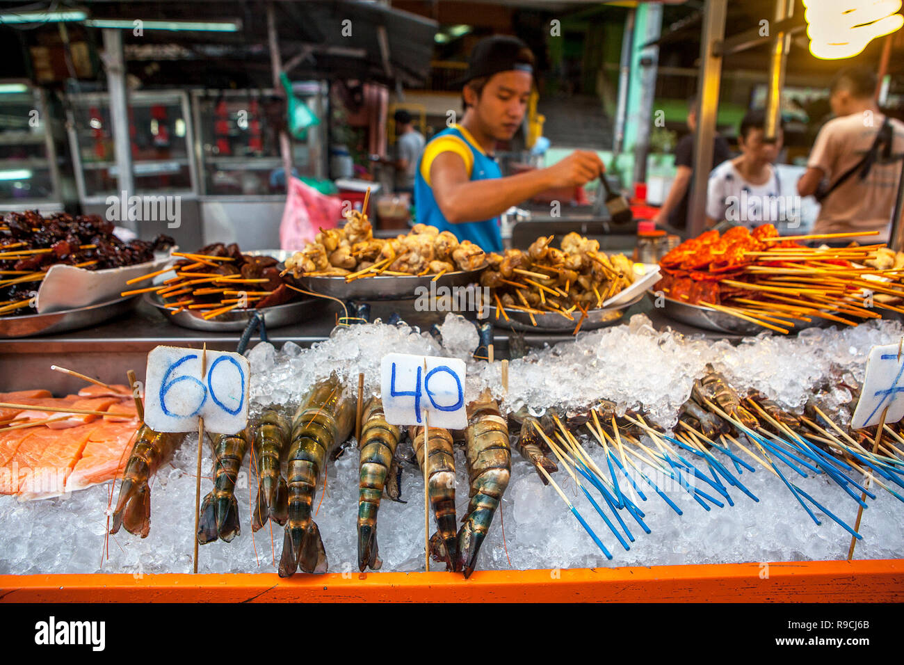 Vendor selling seafood bbq kabobs skewered shrimp on Jalan Alor, Bukit Bintang, Kuala Lumpur, Malaysia. Stock Photo
