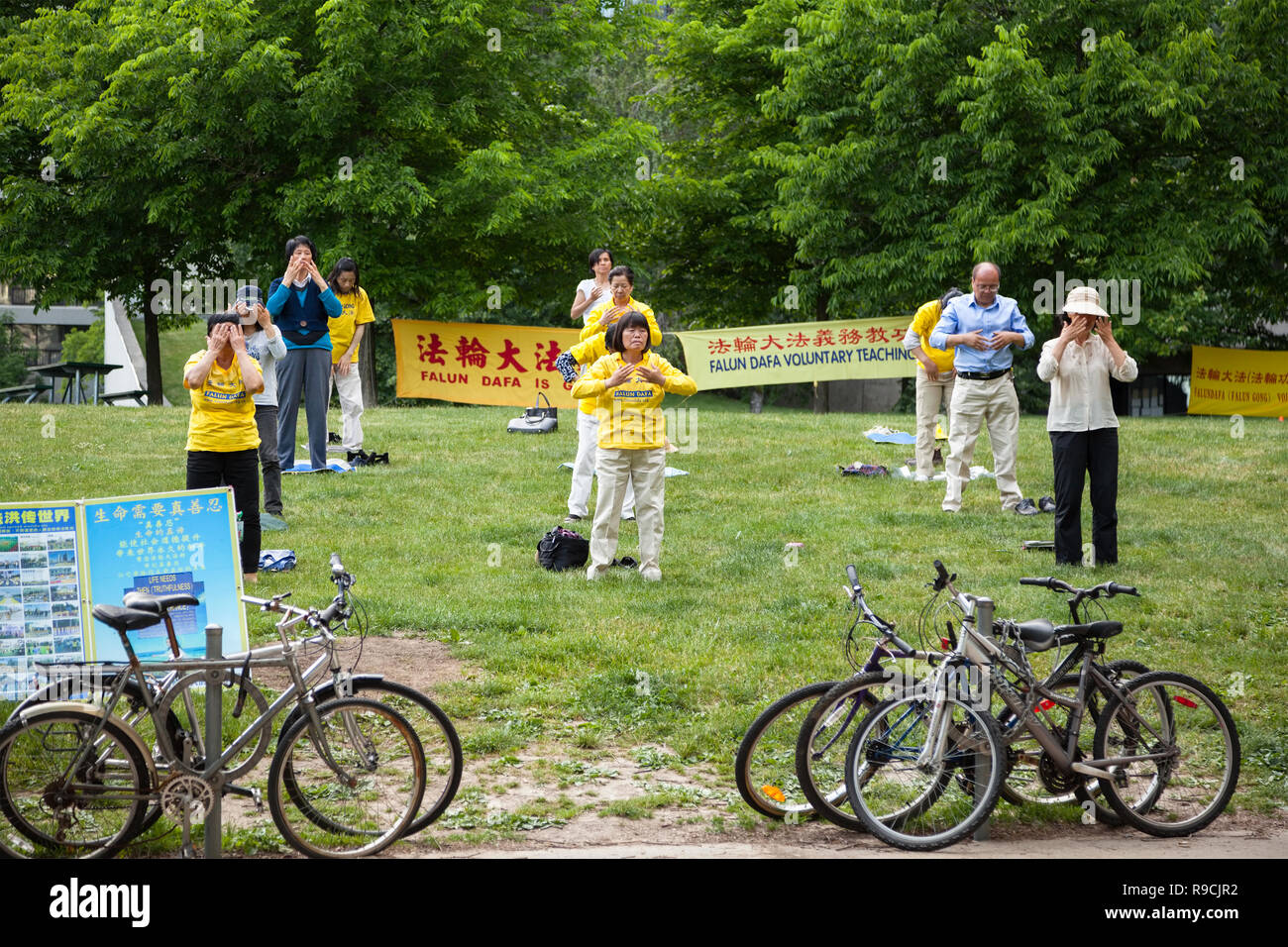People practicing Falun Dafa or Falun Gong which is a Chinese spiritual practice. City of Toronto, Ontario, Canada. Stock Photo