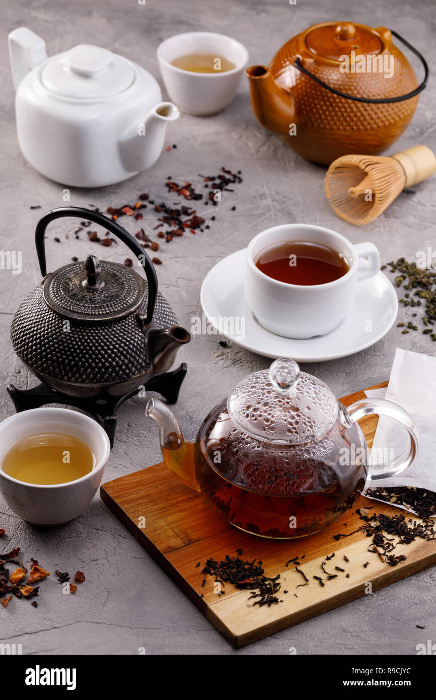 Tea card. Variety of teapots on a gray background, different types of