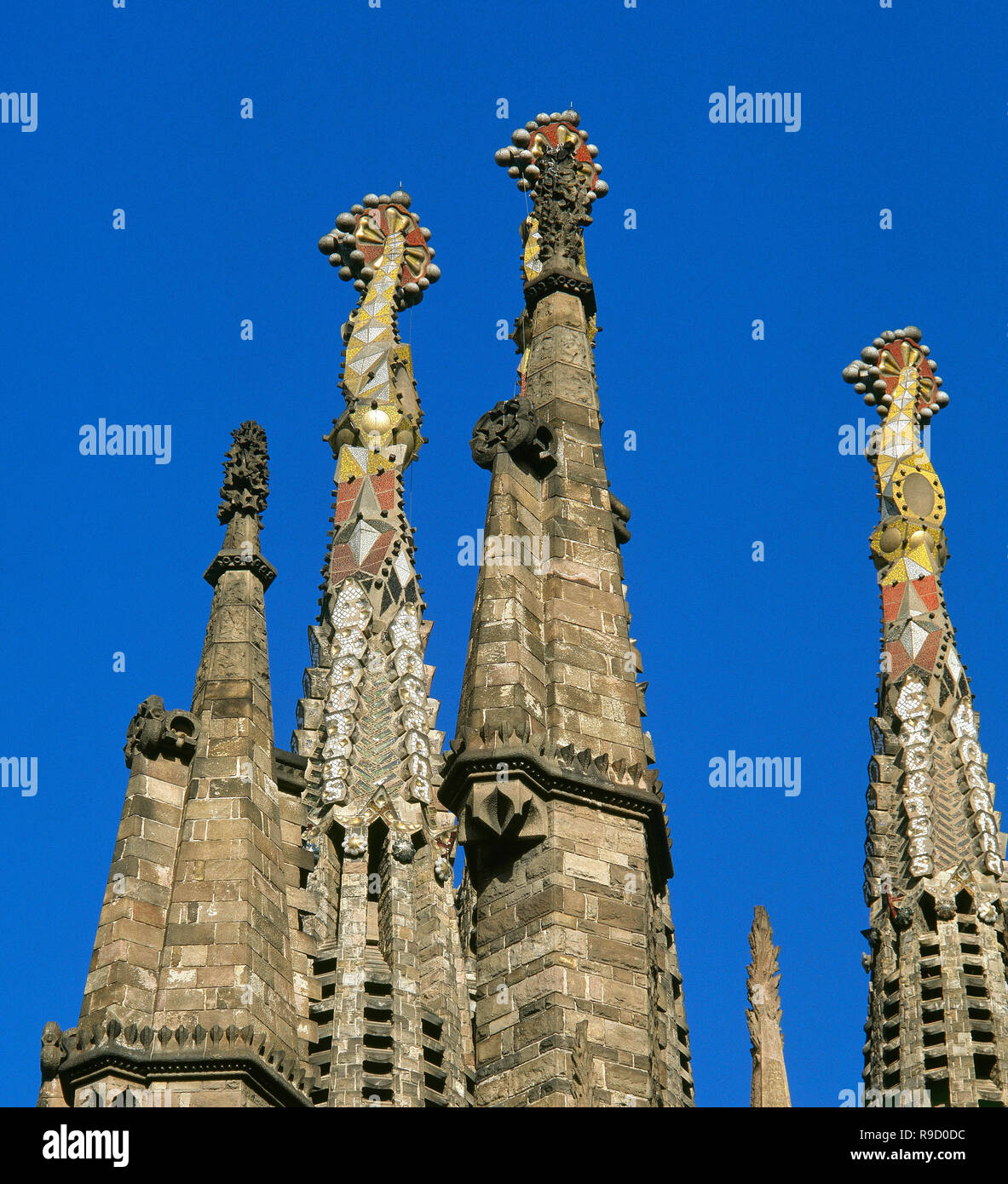 Spain, Catalonia, Barcelona. Basilica of The Sagrada Familia, by Antonio Gaudi (1852-1926). Pinnacles of the towers of the apostles, decorated with technique of 'Trencadis', broken tiles mosaics. Architectural detail. Catalan Modernism style. Unesco World Heritage Site Stock Photo