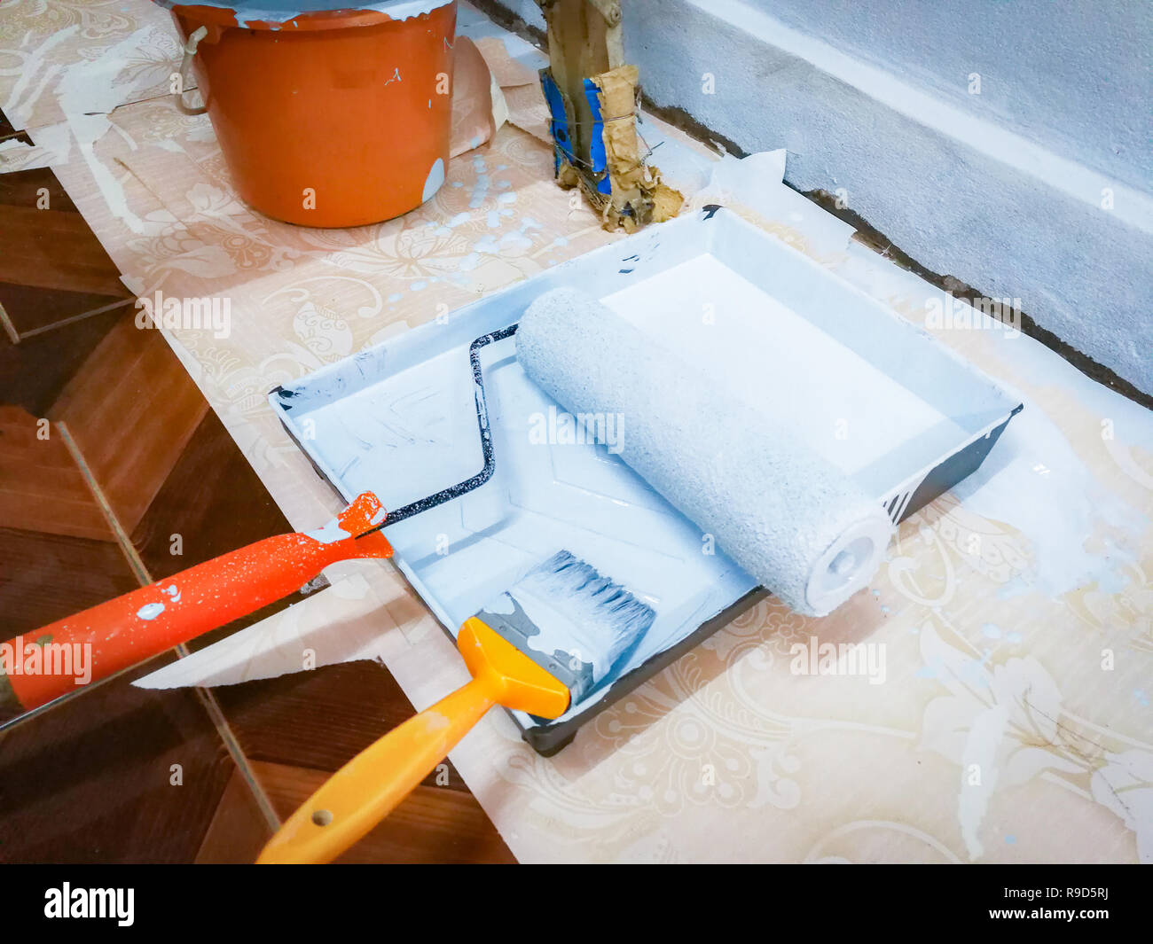 paint bucket on building construction / paint roller and paint brush on