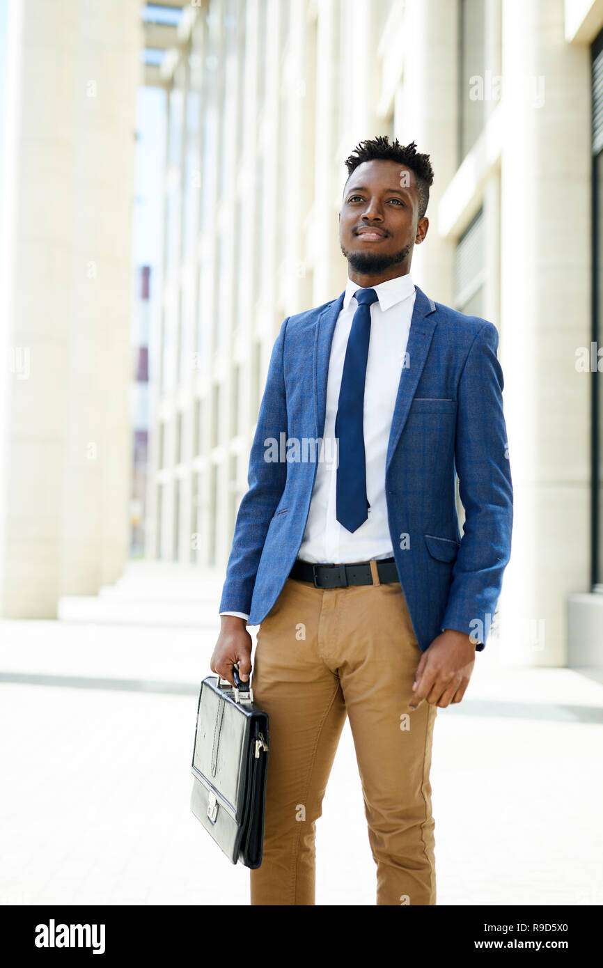 Pensive black entrepreneur with briefcase Stock Photo