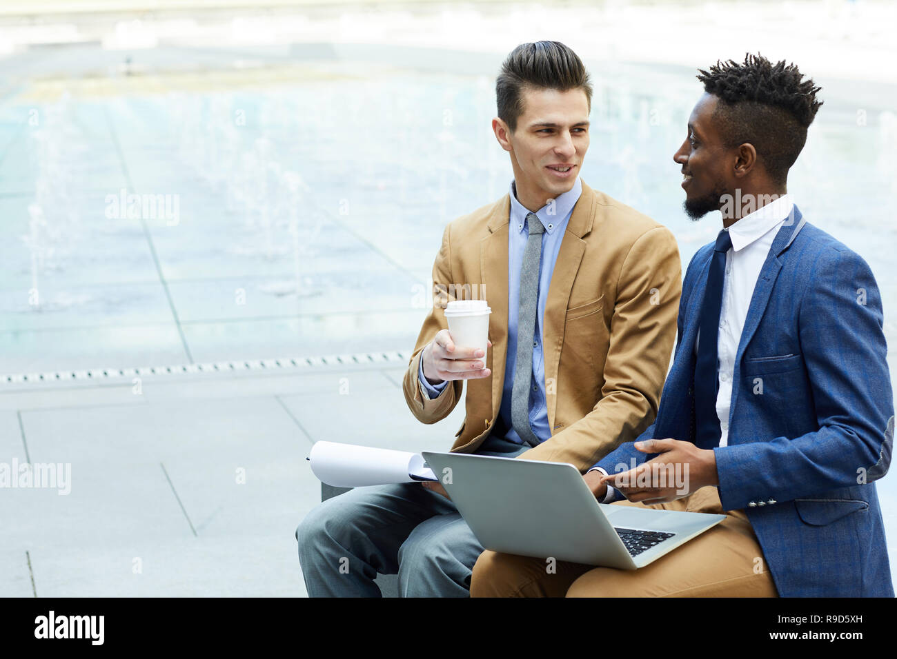 Happy entrepreneurs discussing business Stock Photo