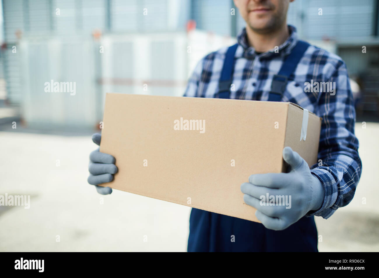 Moving company worker with box Stock Photo