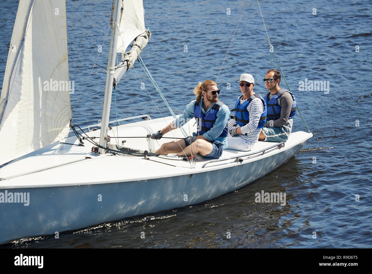 Men sitting on yacht deck Stock Photo