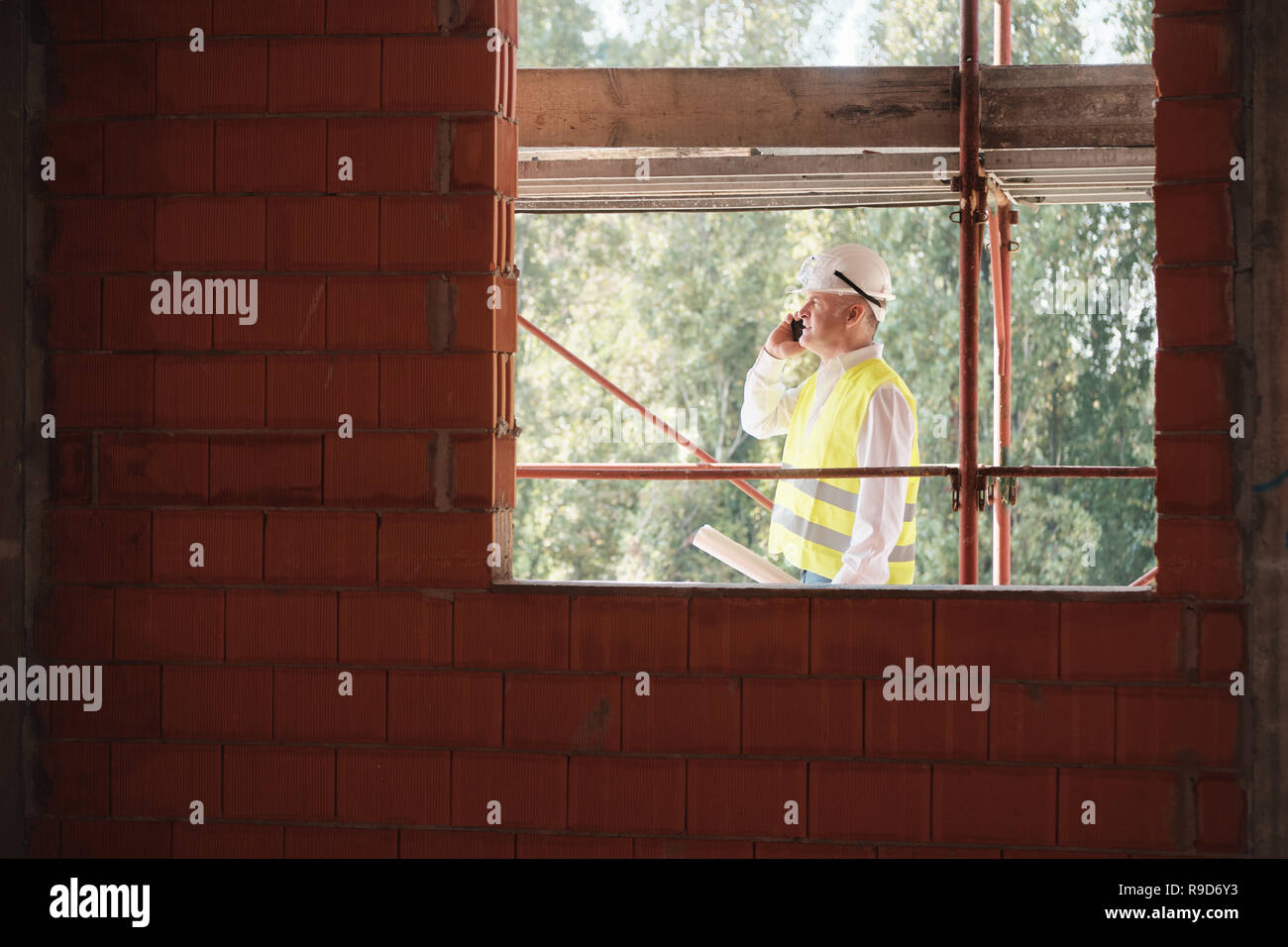 Engineer Talking On Mobile Phone In Construction Site Stock Photo