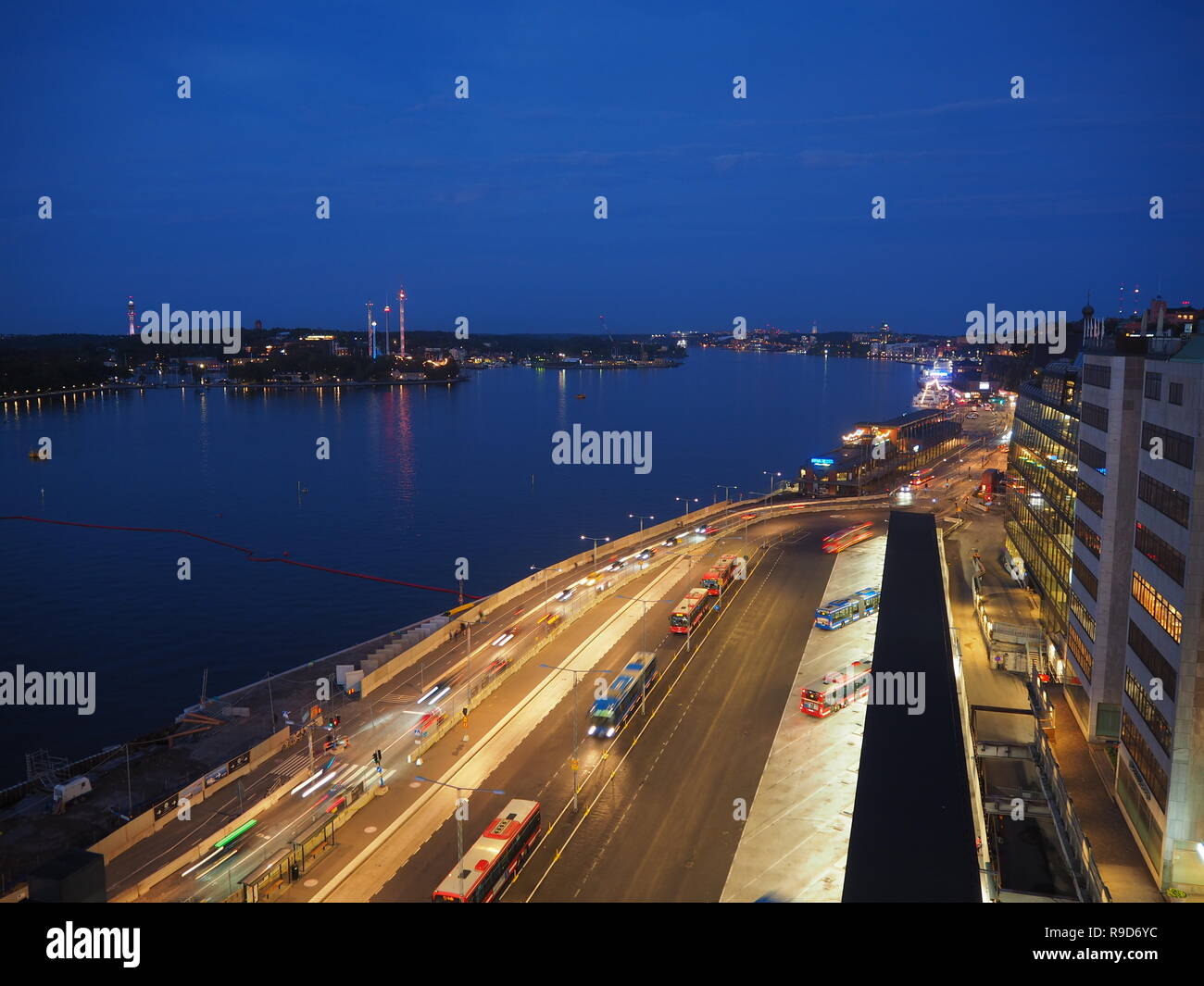 Night view over a bus station and the Baltic Sea from Stockholm, Sweden Stock Photo