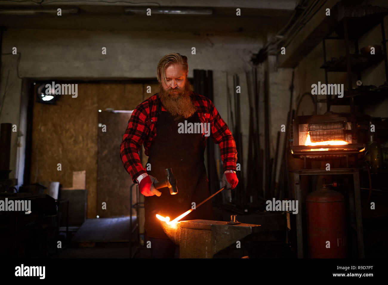 Blacksmith in workshop Stock Photo