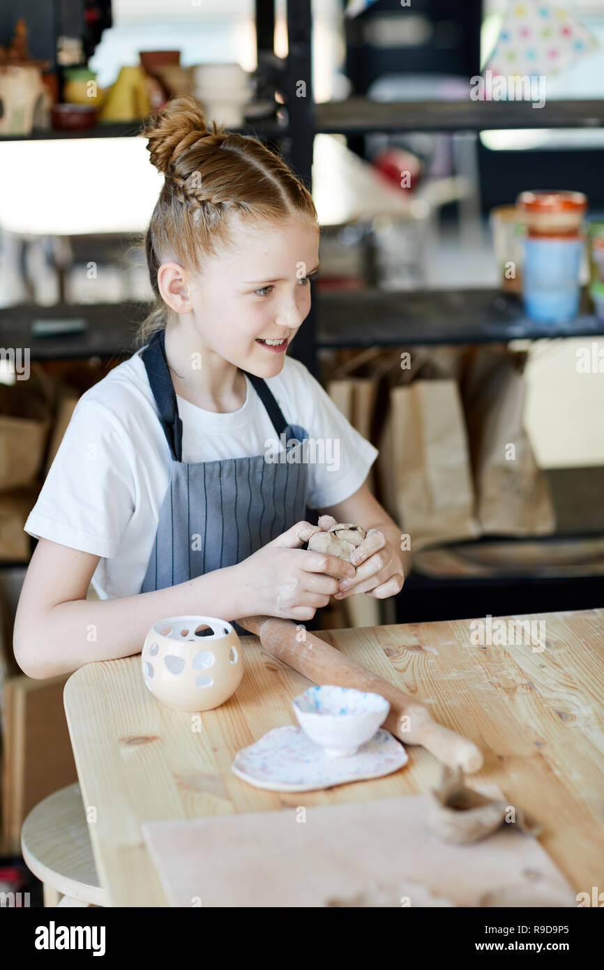 Girl kneading clay Stock Photo
