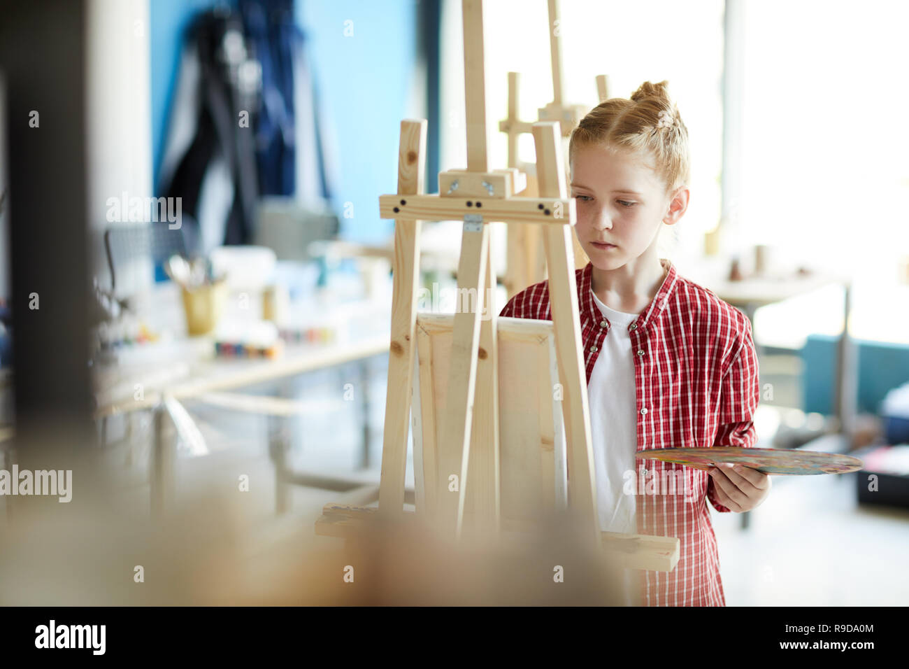 Girl in front of easel Stock Photo - Alamy