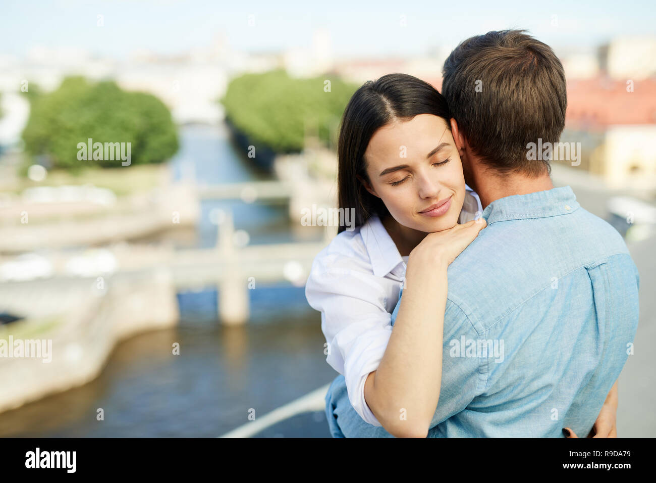 Calm lady with boyfriend on roof Stock Photo