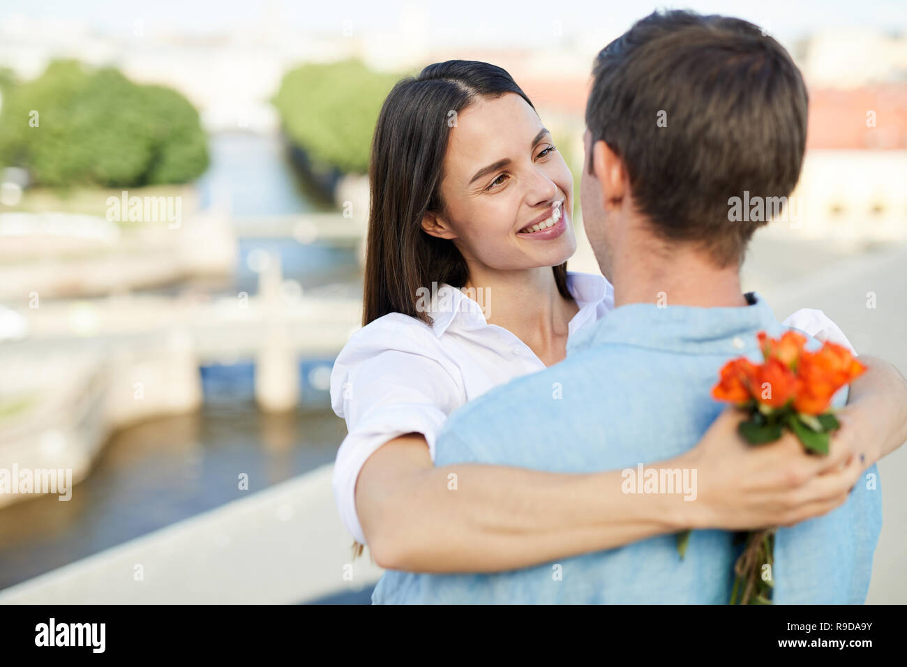 Affectionate girl looking at boyfriend Stock Photo