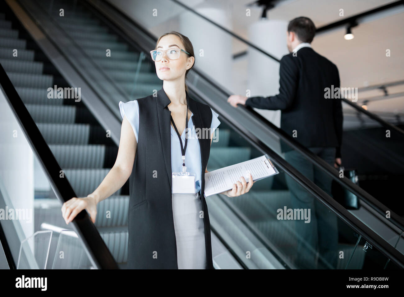Delegate on escalator Stock Photo
