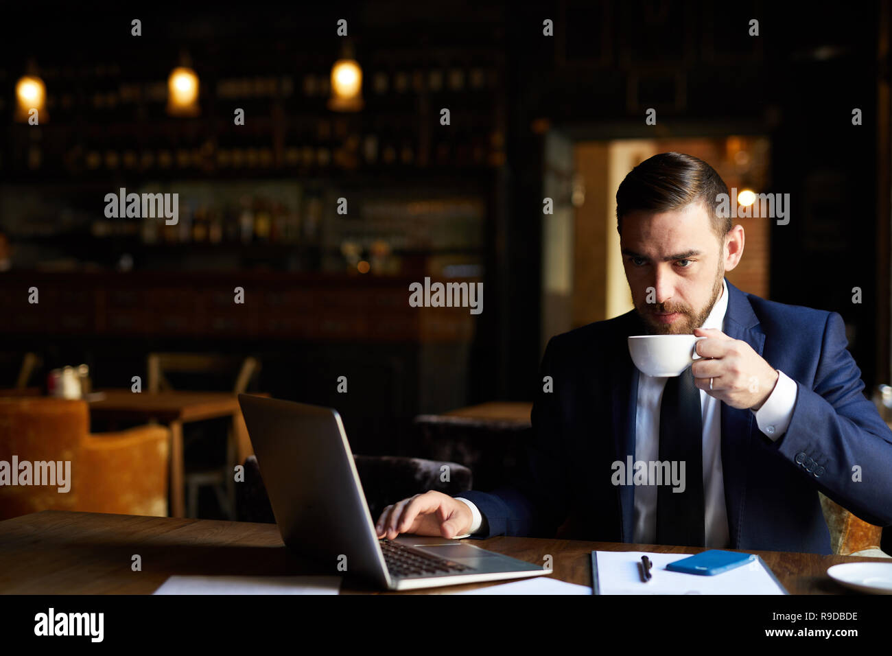 Thoughtful businessman working on report Stock Photo