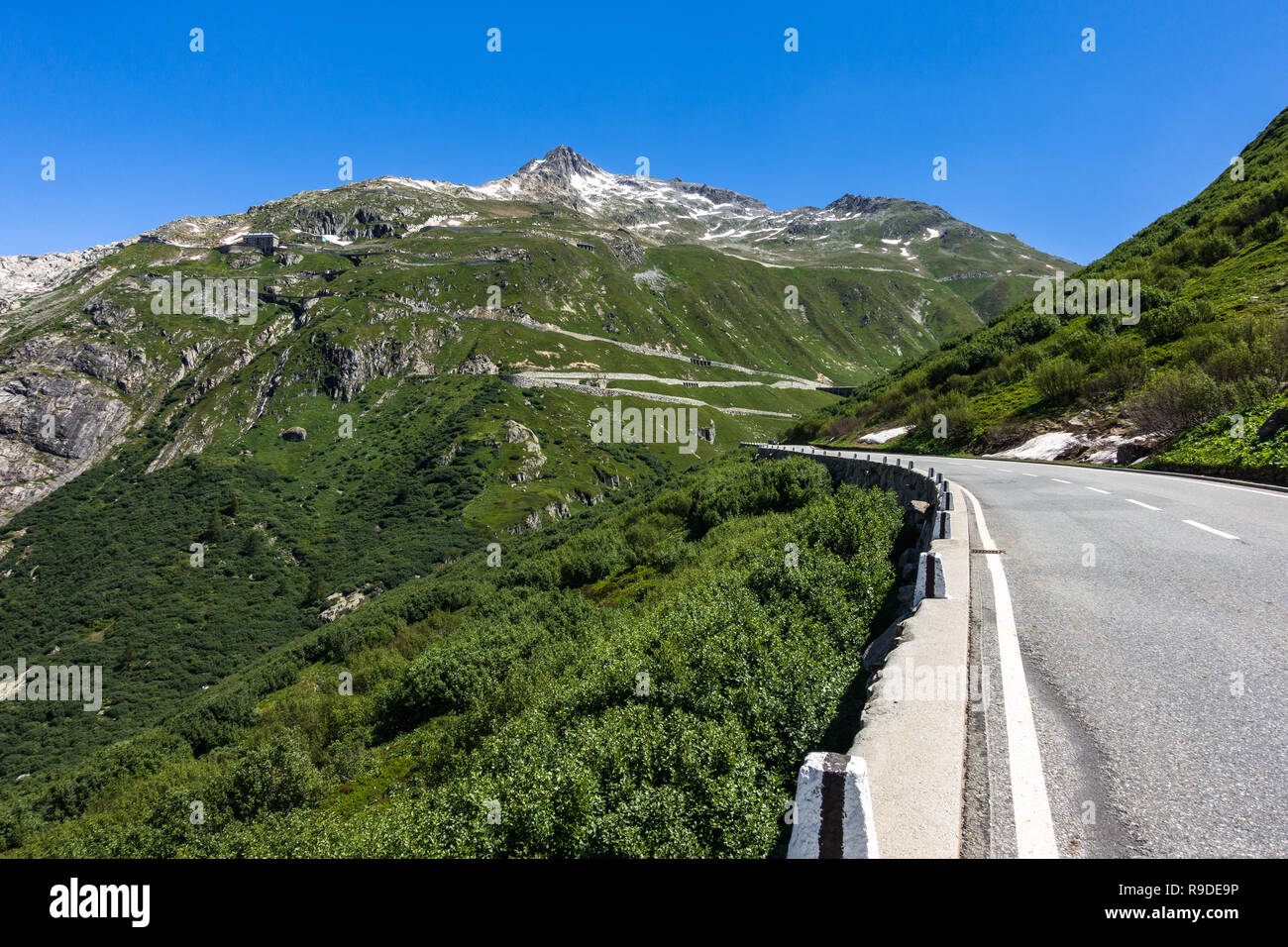 Scenic road to the Furka Pass in the Swiss Alps, very popular among cyclists and motorcyclists, Valais, Switzerland Stock Photo