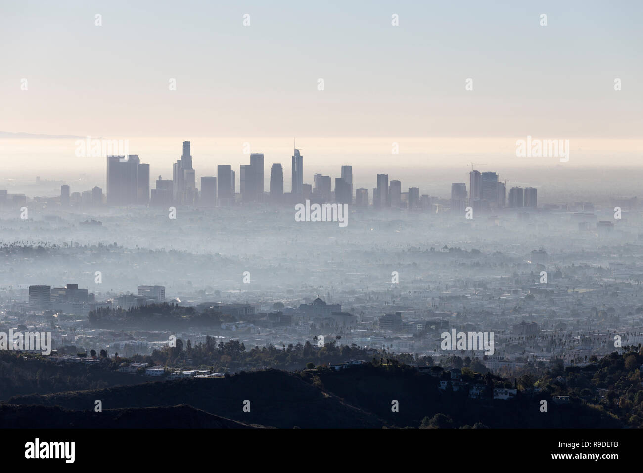 Morning fog cityscape view of downtown Los Angeles from popular Griffith Park near Hollywood California. Stock Photo