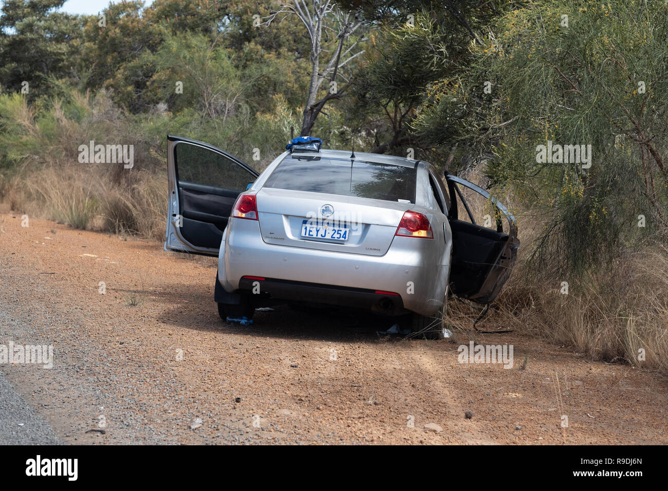 Cataby, Australia. 22nd December, 2018. A silver Commodore involved in a traffic accident sits in bushes after passengers have been conveyed to a nearby ambulance. Credit: Joshua Lawrie/Alamy Live News Stock Photo