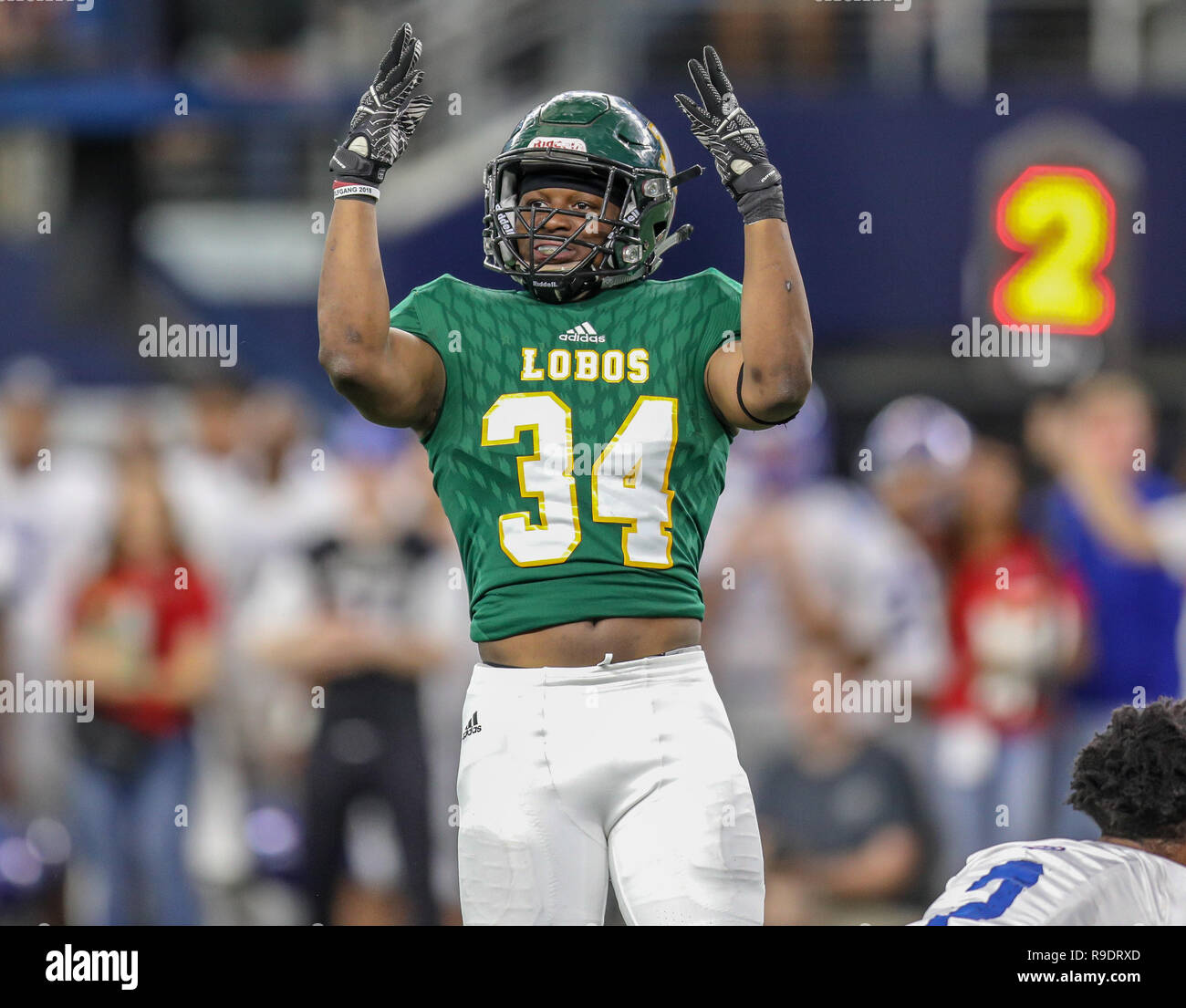 Arlington, Texas, USA. 12th Dec, 2018. Lonview's Tyshawn Taylor #34 celebrates sacking the West Brook QB during the UIL Texas 6A D2 state championship football game between the Longview Lobos and the West Brook Bruins at AT&T Stadium in Arlington, Texas. Kyle Okita/CSM/Alamy Live News Stock Photo