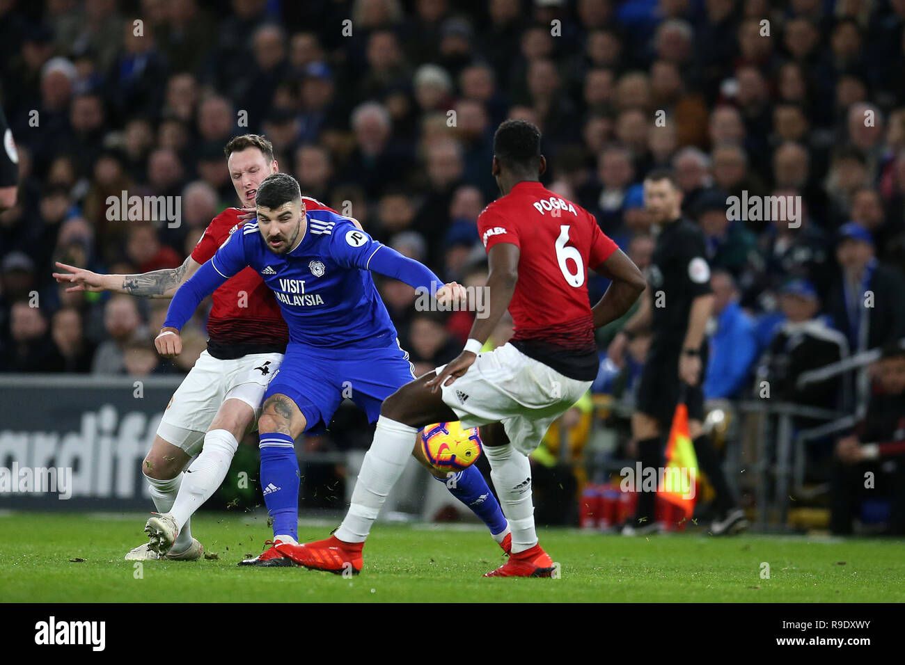 Cardiff, UK. 22nd Dec, 2018. Callum Paterson of Cardiff city Credit: is challenged by Phil Jones (l) and Paul Pogba of Manchester United . Premier League match, Cardiff City v Manchester Utd at the Cardiff City Stadium on Saturday 22nd December 2018. this image may only be used for Editorial purposes. Editorial use only, license required for commercial use. No use in betting, games or a single club/league/player publications. pic by Andrew Orchard/Andrew Orchard sports photography/Alamy Live News Stock Photo