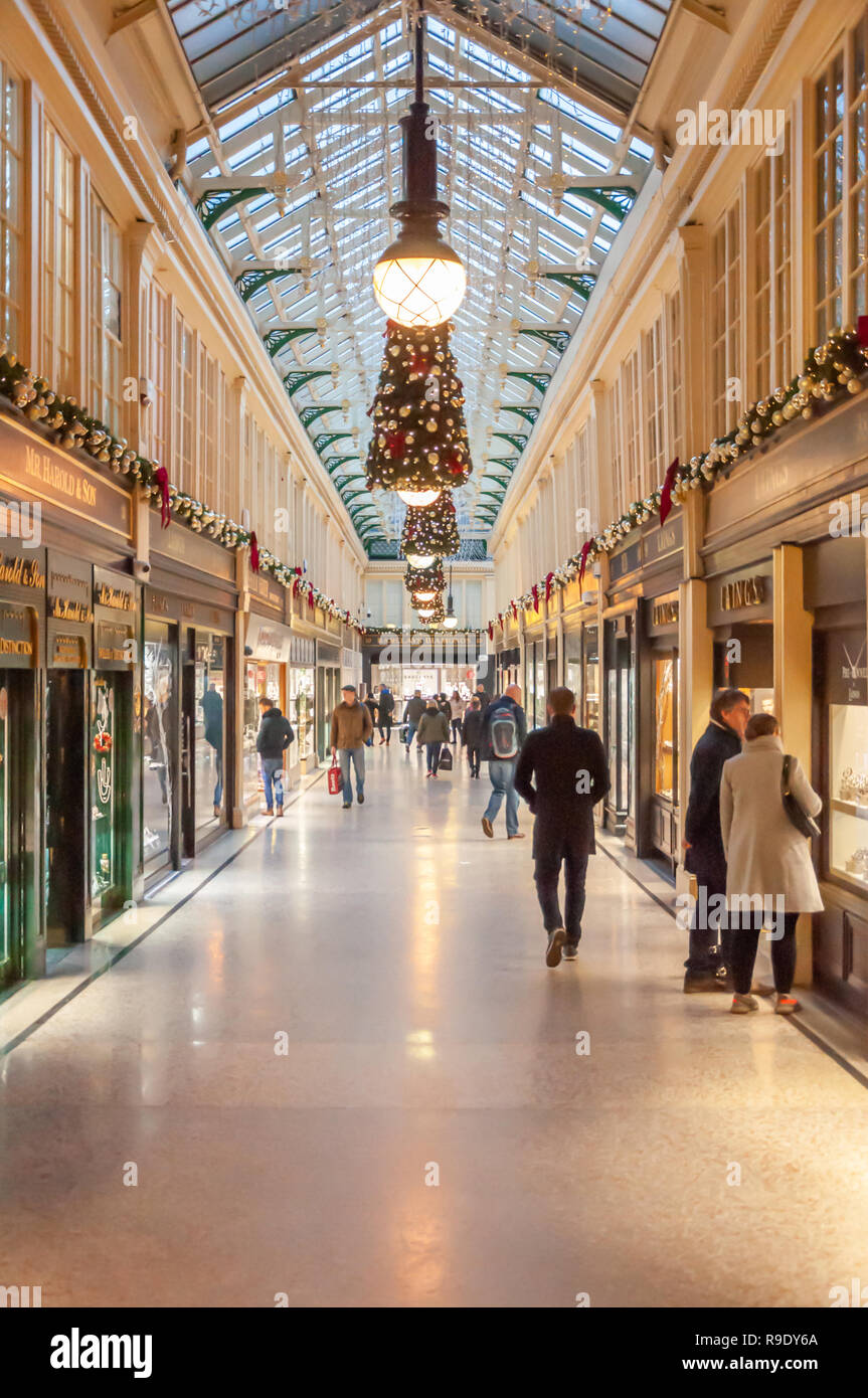 Glasgow, Scotland, UK. 23rd December, 2018. Christmas shoppers in Argyll Arcade which contains a large selection of jewellery shops. The Arcade was designed by John Baird and built in 1827, it is L-shaped and links Argyle Street with Buchanan Street. The arcade was Grade A listed in 1970. Credit: Skully/Alamy Live News Stock Photo