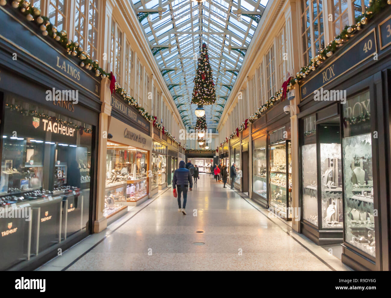 Glasgow, Scotland, UK. 23rd December, 2018. Christmas shoppers in Argyll Arcade which contains a large selection of jewellery shops. The Arcade was designed by John Baird and built in 1827, it is L-shaped and links Argyle Street with Buchanan Street. The arcade was Grade A listed in 1970. Credit: Skully/Alamy Live News Stock Photo
