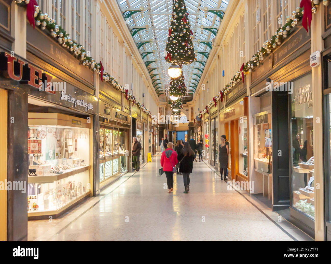 Glasgow, Scotland, UK. 23rd December, 2018. Christmas shoppers in Argyll Arcade which contains a large selection of jewellery shops. The Arcade was designed by John Baird and built in 1827, it is L-shaped and links Argyle Street with Buchanan Street. The arcade was Grade A listed in 1970. Credit: Skully/Alamy Live News Stock Photo