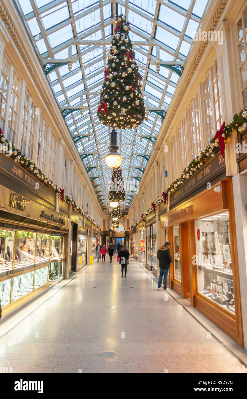 Glasgow, Scotland, UK. 23rd December, 2018. Christmas shoppers in Argyll Arcade which contains a large selection of jewellery shops. The Arcade was designed by John Baird and built in 1827, it is L-shaped and links Argyle Street with Buchanan Street. The arcade was Grade A listed in 1970. Credit: Skully/Alamy Live News Stock Photo