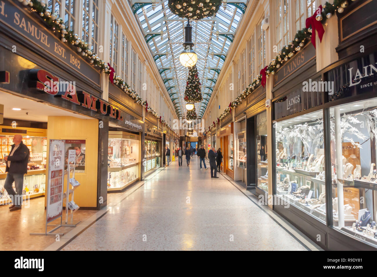 Glasgow, Scotland, UK. 23rd December, 2018. Christmas shoppers in Argyll Arcade which contains a large selection of jewellery shops. The Arcade was designed by John Baird and built in 1827, it is L-shaped and links Argyle Street with Buchanan Street. The arcade was Grade A listed in 1970. Credit: Skully/Alamy Live News Stock Photo