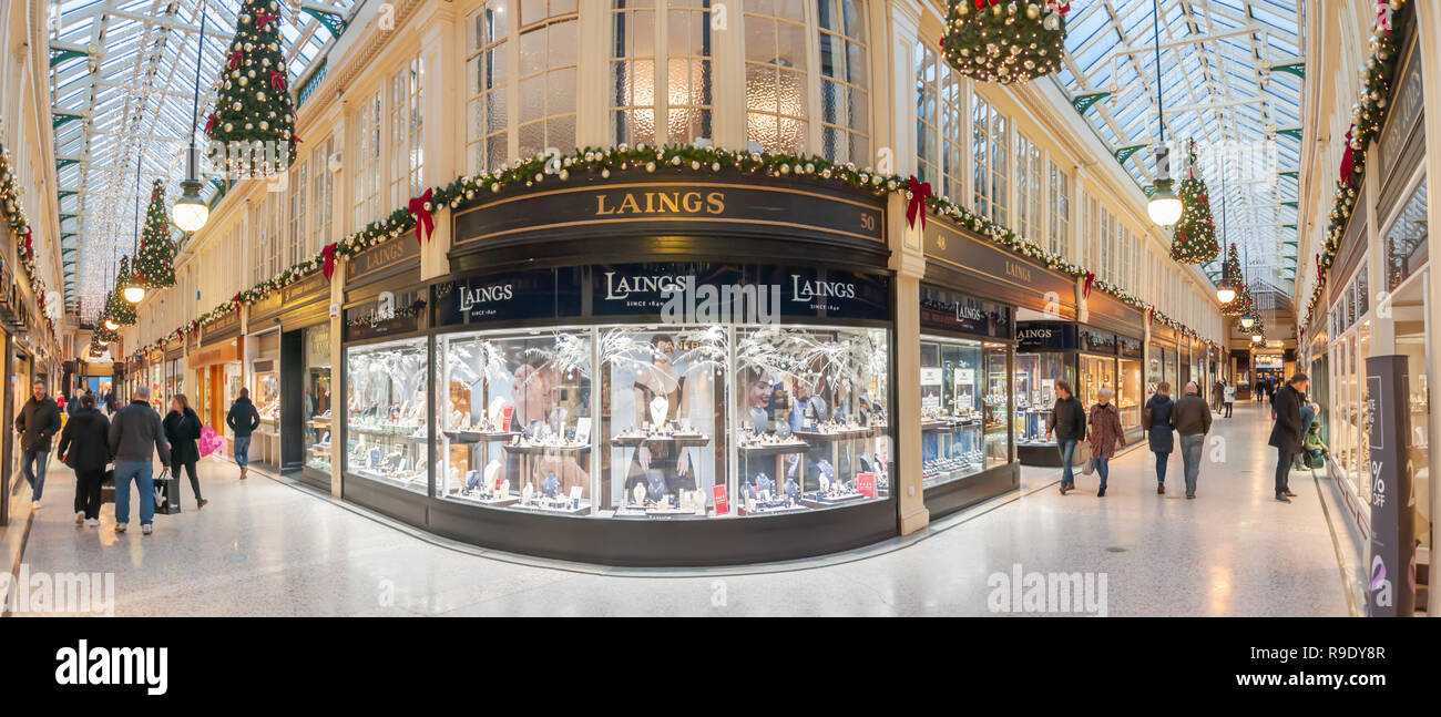Glasgow, Scotland, UK. 23rd December, 2018. Christmas shoppers in Argyll Arcade which contains a large selection of jewellery shops. The Arcade was designed by John Baird and built in 1827, it is L-shaped and links Argyle Street with Buchanan Street. The arcade was Grade A listed in 1970. Credit: Skully/Alamy Live News Stock Photo