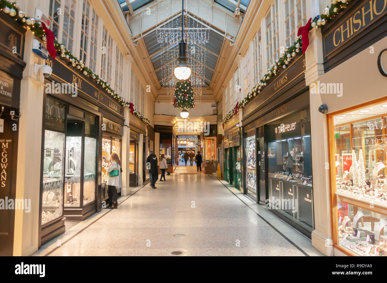 Glasgow, Scotland, UK. 23rd December, 2018. Christmas shoppers in Argyll Arcade which contains a large selection of jewellery shops. The Arcade was designed by John Baird and built in 1827, it is L-shaped and links Argyle Street with Buchanan Street. The arcade was Grade A listed in 1970. Credit: Skully/Alamy Live News Stock Photo
