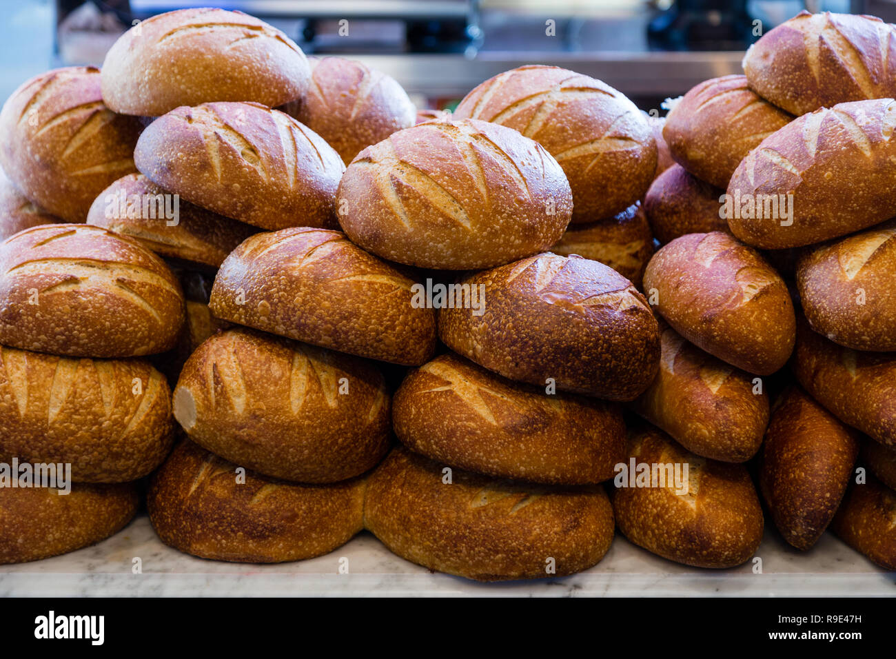 Fresh sourdough bread stacked in a bakery ready to sell and eat Stock