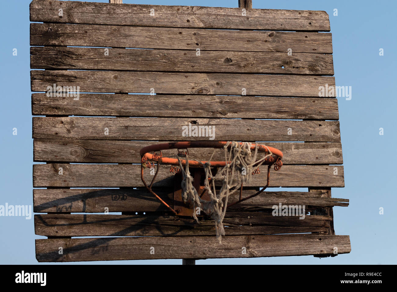 Old and rusty basketball hoop with tangled net Stock Photo