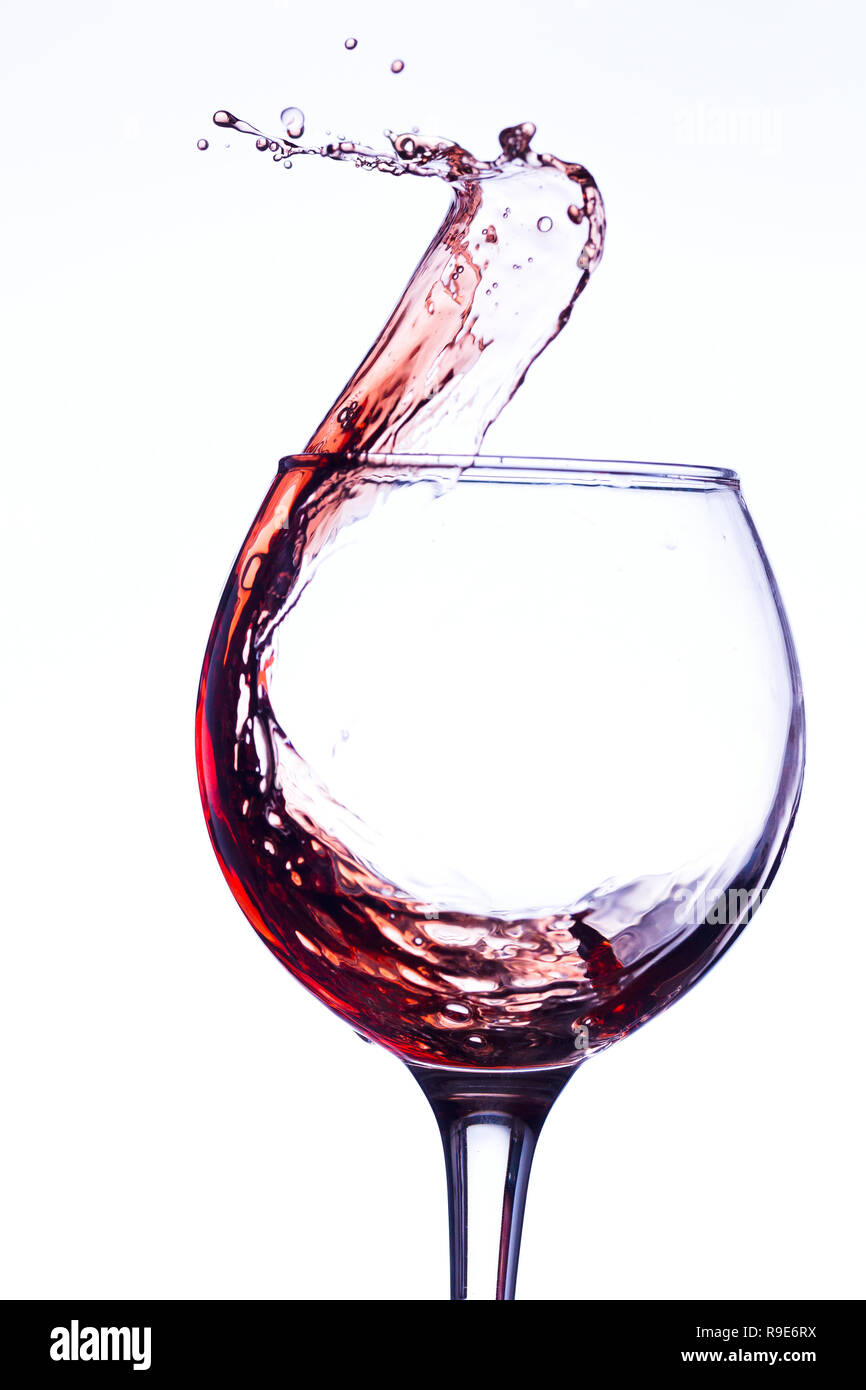 Wine splashing in glass, acrylic background, studio lighting Stock Photo