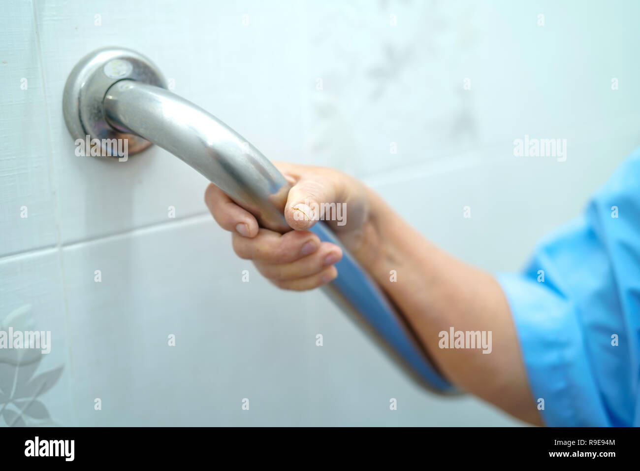Asian senior or elderly old lady woman patient use toilet handle security in nursing hospital ward : healthy strong medical concept. Stock Photo