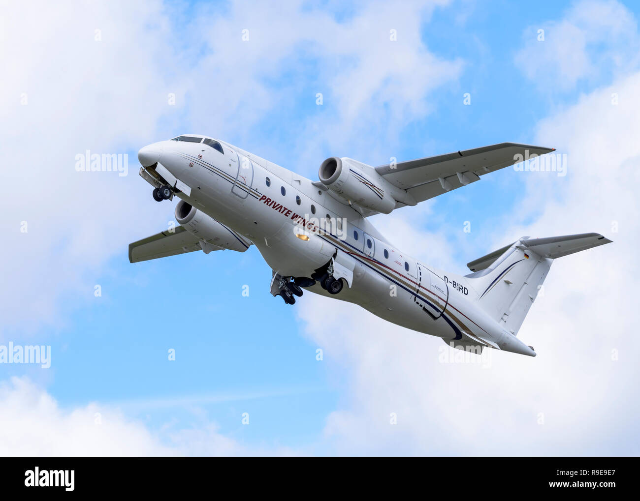 Fairchild-Dornier 328JET commuter airliner, in Private Wings Flugcharter livery, retracts its wheels after take-off. Stock Photo